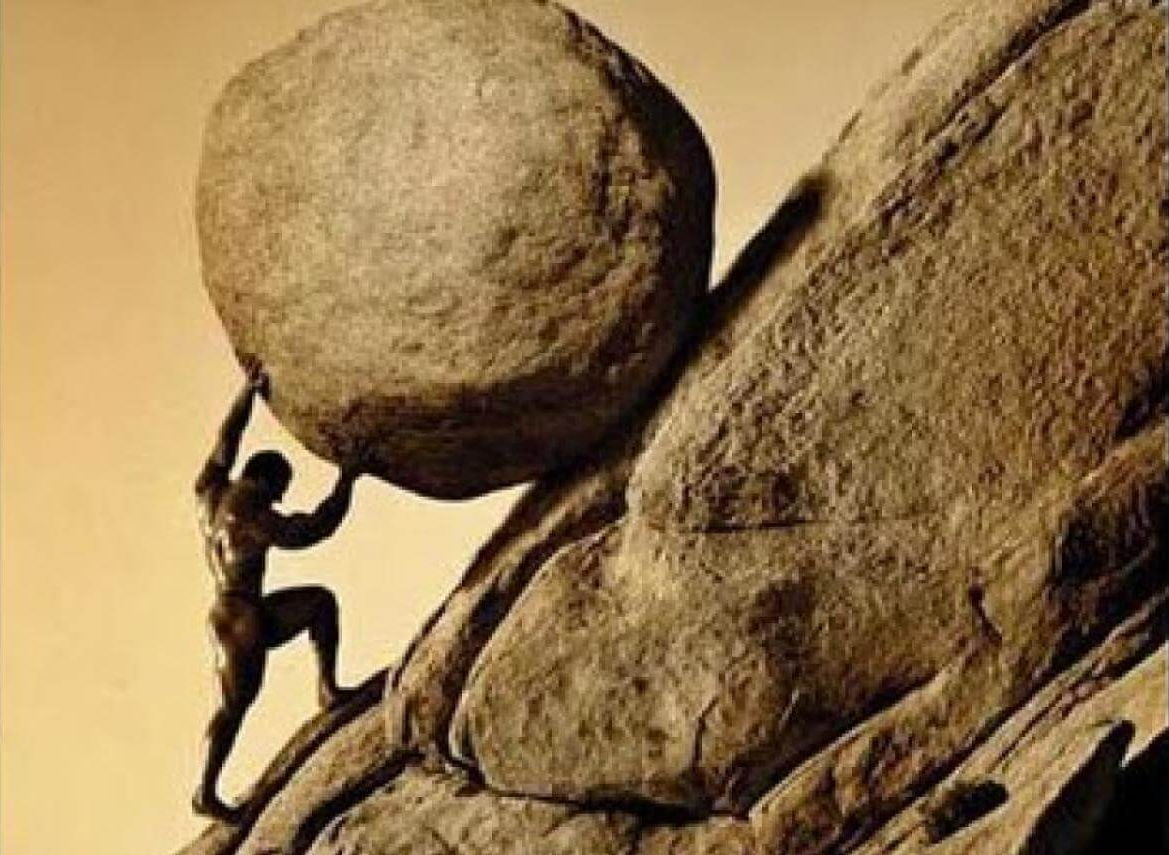 Sisyphus rolls a boulder up a hill.